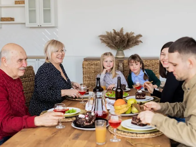 Grandparents, parents and children at the celebration table, as a family